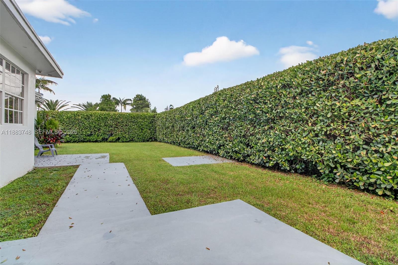 8371 Southwest 32nd Terrace Miami, FL 33155 - Photo 33 of 48 a view of a garden with a building in the background