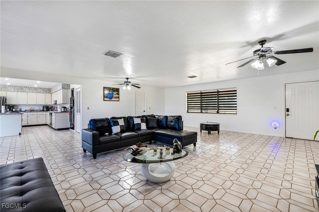 1472 Charolais Road Northwest LaBelle, FL 33935 - Photo 11 of 50 a living room with furniture and a chandelier