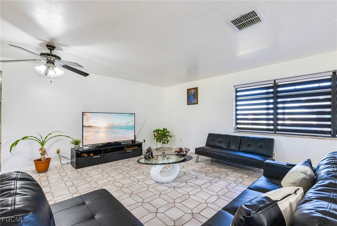 1472 Charolais Road Northwest LaBelle, FL 33935 - Photo 14 of 50 a living room with furniture flowerpot and window