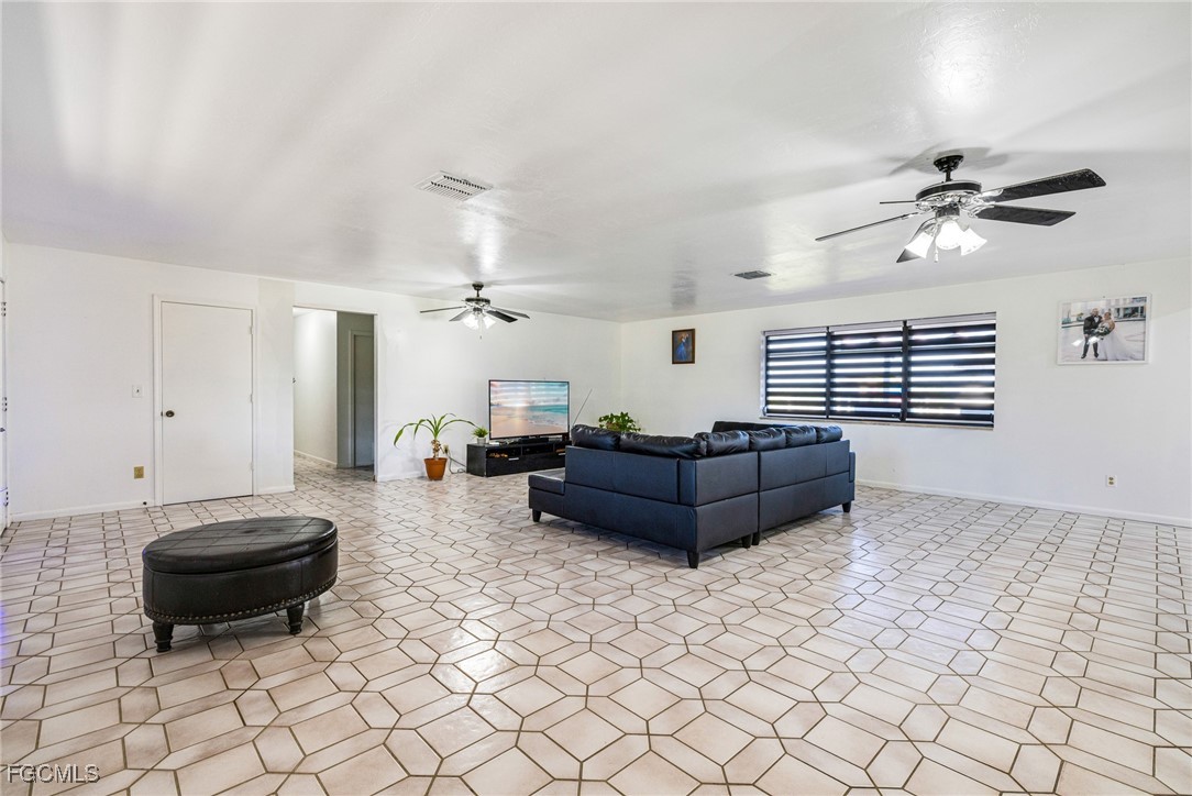 1472 Charolais Road Northwest LaBelle, FL 33935 - Photo 16 of 50 a living room with furniture and a chandelier