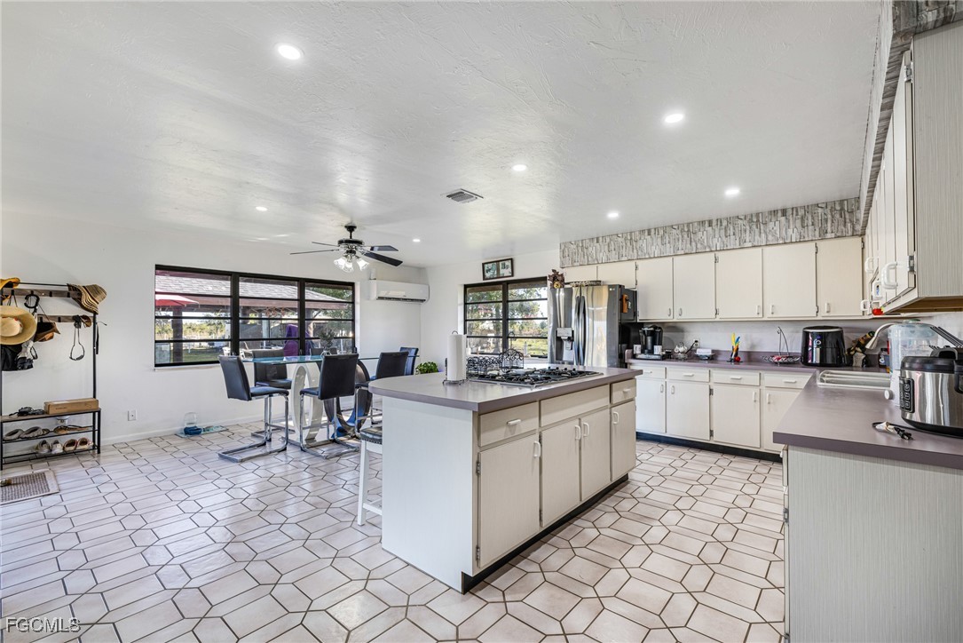 1472 Charolais Road Northwest LaBelle, FL 33935 - Photo 17 of 50 a kitchen with white cabinets and sink