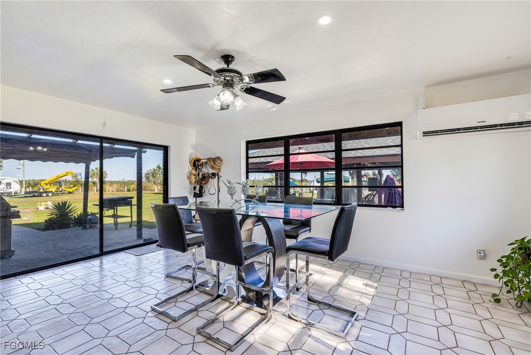 1472 Charolais Road Northwest LaBelle, FL 33935 - Photo 21 of 50 a dining room with furniture a chandelier and wooden floor