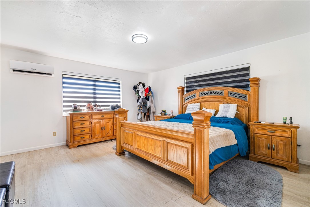 1472 Charolais Road Northwest LaBelle, FL 33935 - Photo 22 of 50 a bed room with a bed and a couch