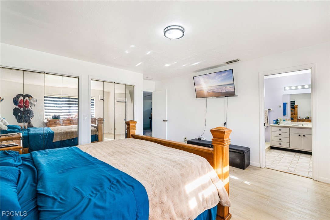 1472 Charolais Road Northwest LaBelle, FL 33935 - Photo 24 of 50 a bedroom with a bed and a couch