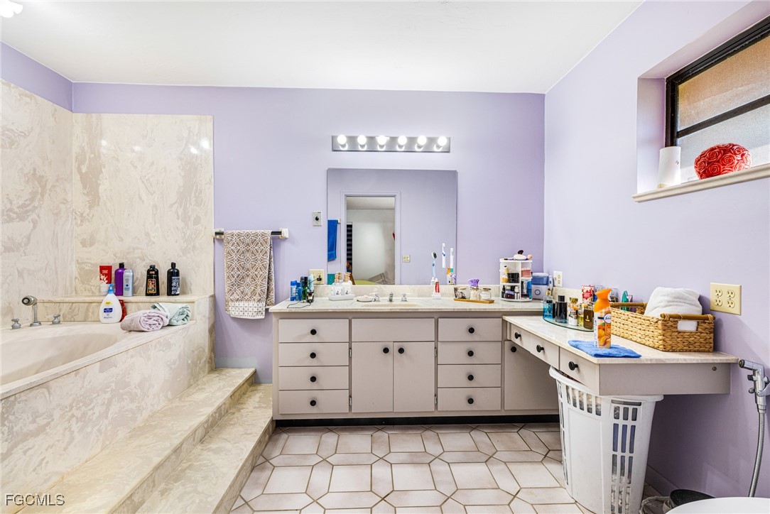 1472 Charolais Road Northwest LaBelle, FL 33935 - Photo 25 of 50 a spacious bathroom with a double vanity sink mirror and double