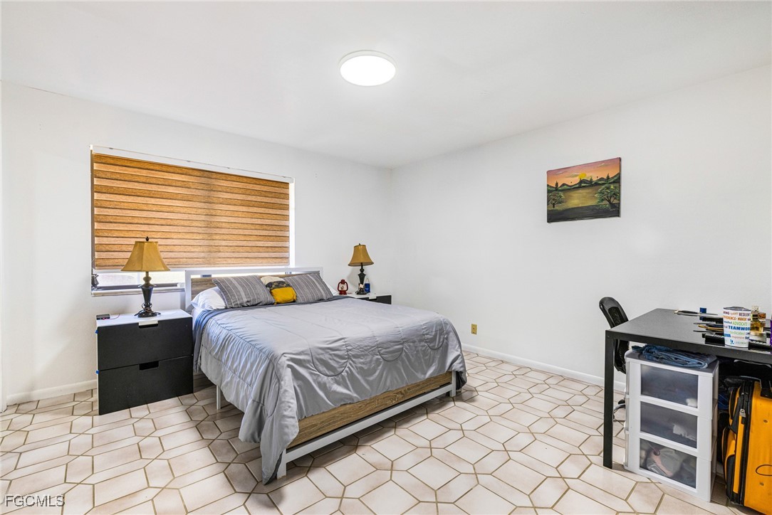 1472 Charolais Road Northwest LaBelle, FL 33935 - Photo 27 of 50 a bedroom with a bed and a table in it