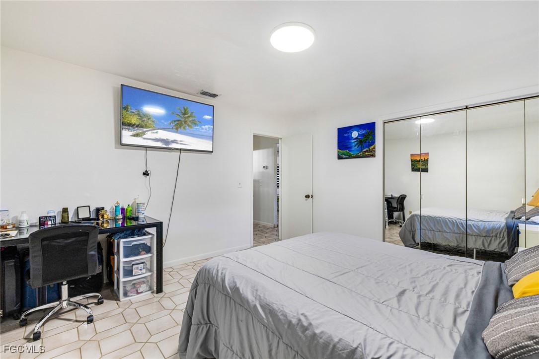 1472 Charolais Road Northwest LaBelle, FL 33935 - Photo 29 of 50 a bedroom with a bed and a desk