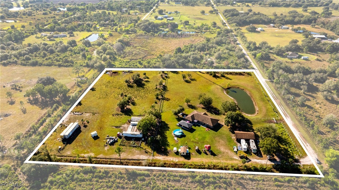 1472 Charolais Road Northwest LaBelle, FL 33935 - Photo 37 of 50 a view of swimming pool with a garden