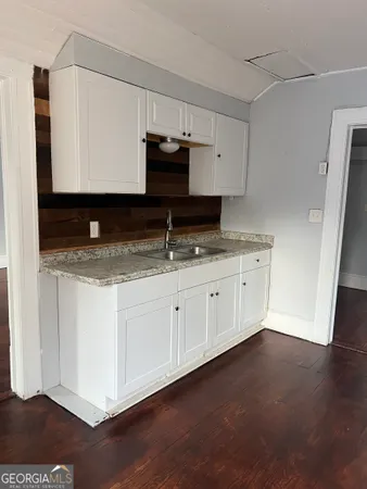a kitchen with granite countertop cabinets stainless steel appliances and a sink