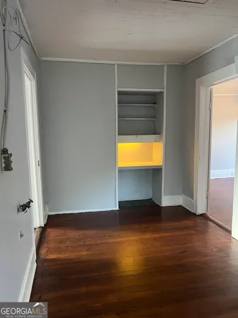 a room with wooden floor and a table