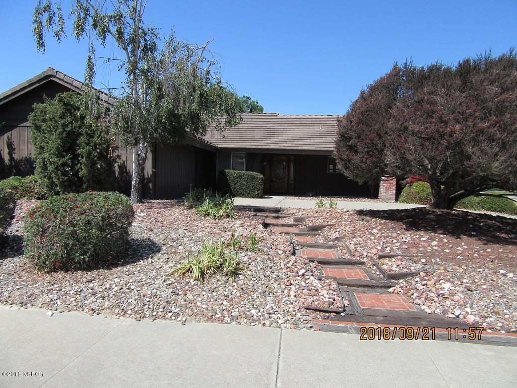 a wooden bench sitting in front of a house