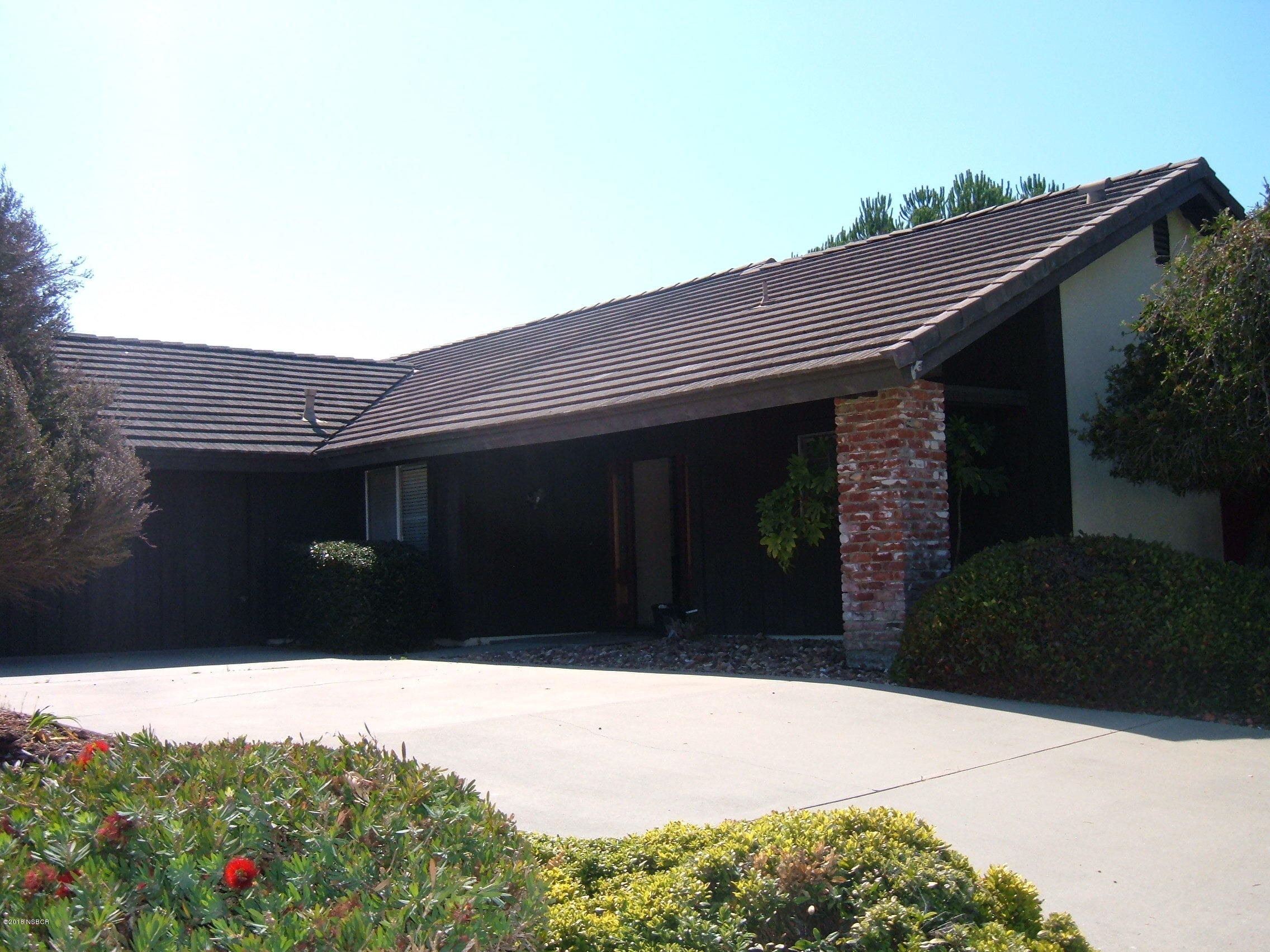 4376 Rigel Avenue Lompoc, CA 93436 - Photo 2 of 20 a black and white building with trees in front of it