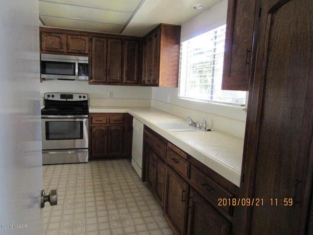 4376 Rigel Avenue Lompoc, CA 93436 - Photo 5 of 20 a kitchen with a sink a stove and cabinets