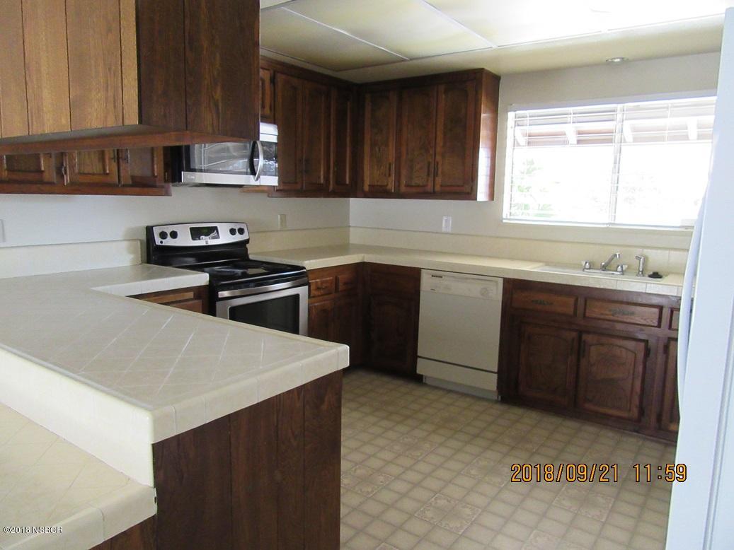 4376 Rigel Avenue Lompoc, CA 93436 - Photo 6 of 20 a kitchen with stainless steel appliances a sink stove and cabinets