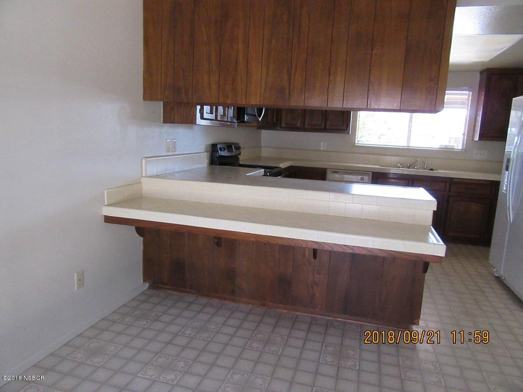 4376 Rigel Avenue Lompoc, CA 93436 - Photo 7 of 20 a kitchen with a sink cabinets and a window