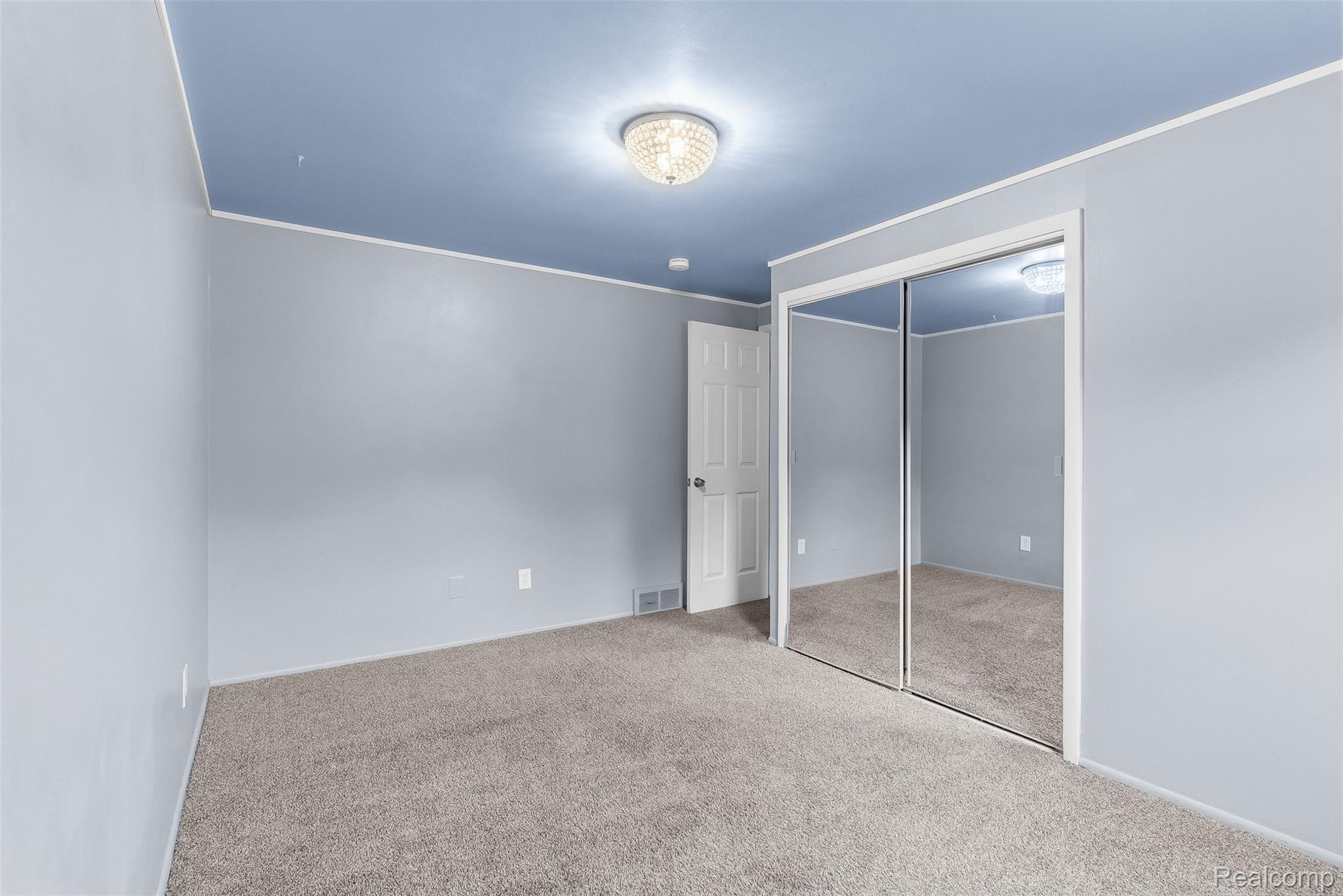 819 Alpine Trail Fenton, MI 48430 - Photo 20 of 41 Wall-to-wall carpet flooring, mirrored closet doors, and overhead lighting