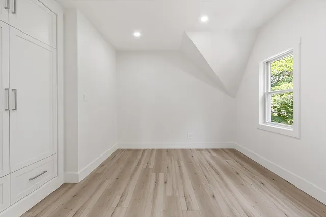 a view of room with window and hardwood floor