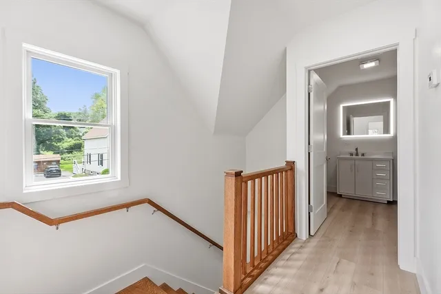 a view of a hallway with a window and a livingroom