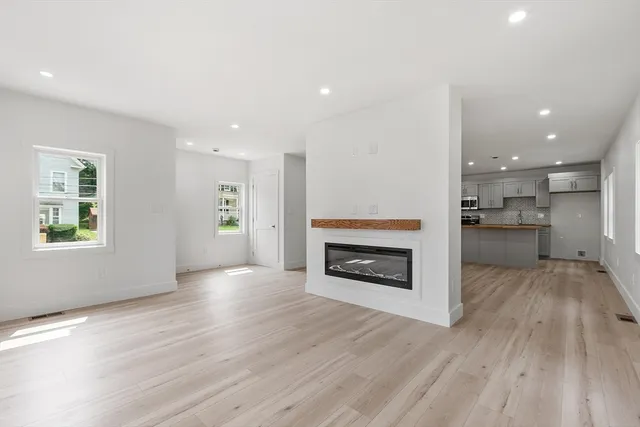 a view of a kitchen with a sink and a fireplace