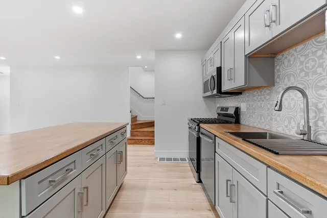 a kitchen with stainless steel appliances granite countertop a sink and cabinets