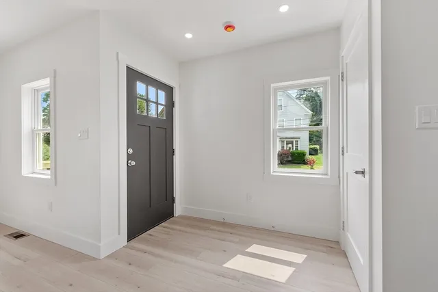 an empty room with windows and closet