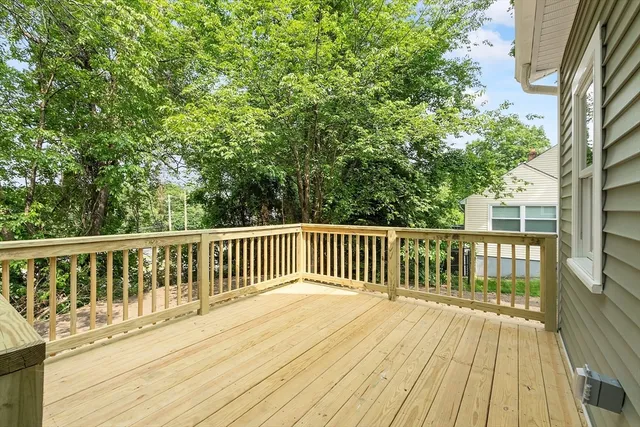 a view of balcony with wooden floor and fence