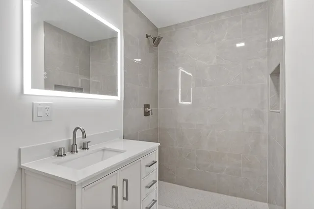 a bathroom with a sink a toilet and shower