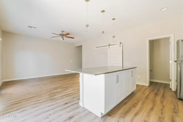 a view of a room with wooden floor