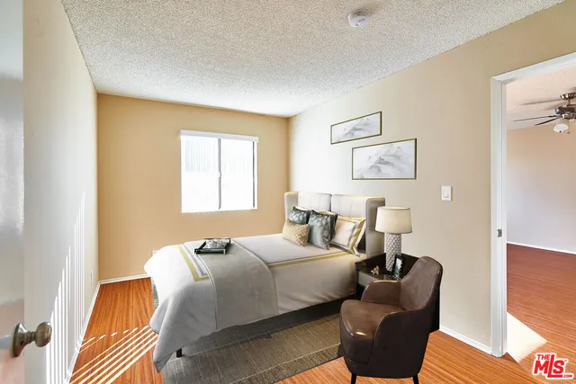 a bedroom with bed and window