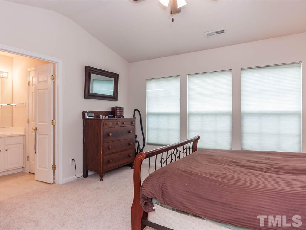 8149 Rhiannon Road Raleigh, NC 27613 - Photo 14 of 25 a bedroom with a bed and a window