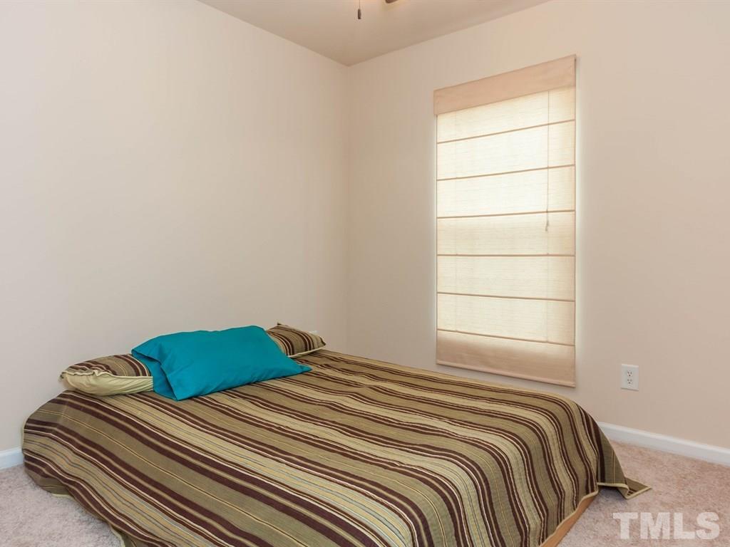 8149 Rhiannon Road Raleigh, NC 27613 - Photo 16 of 25 a bedroom with a bed and a window