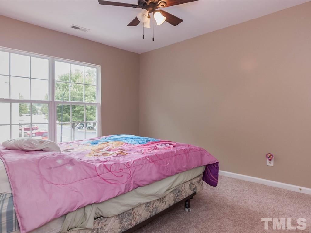 8149 Rhiannon Road Raleigh, NC 27613 - Photo 18 of 25 a bedroom with a bed and window
