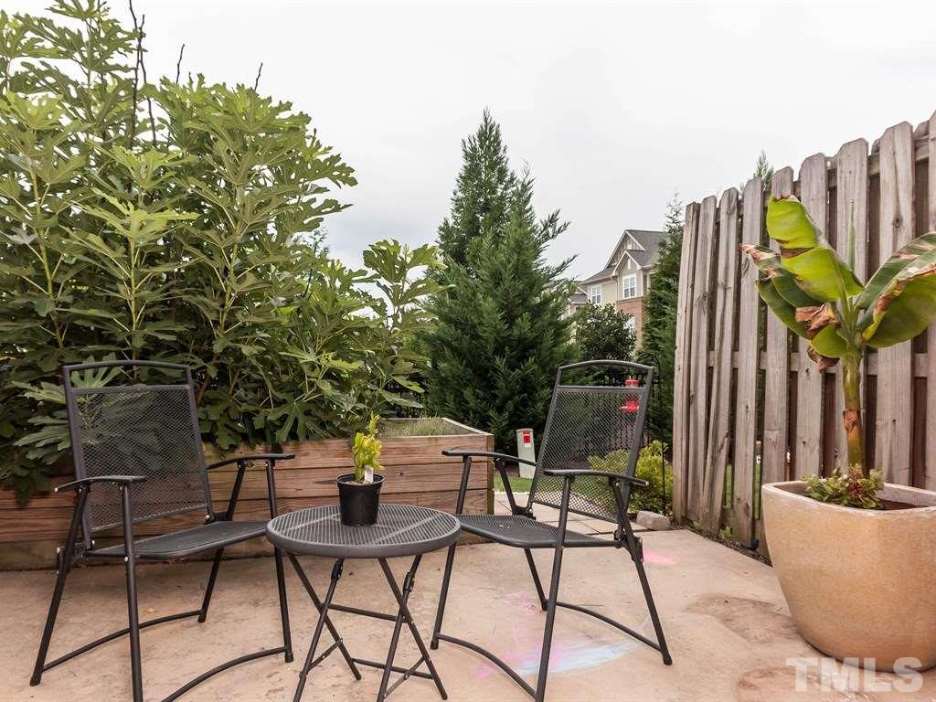 8149 Rhiannon Road Raleigh, NC 27613 - Photo 19 of 25 a view of a chairs and table in a backyard