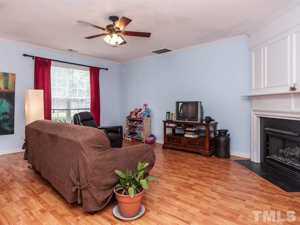 8149 Rhiannon Road Raleigh, NC 27613 - Photo 3 of 25 a living room with furniture fireplace and window