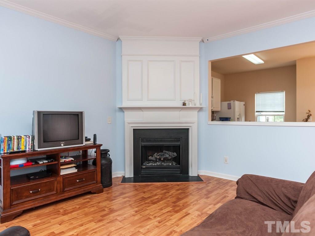 8149 Rhiannon Road Raleigh, NC 27613 - Photo 4 of 25 a living room with furniture and a fireplace