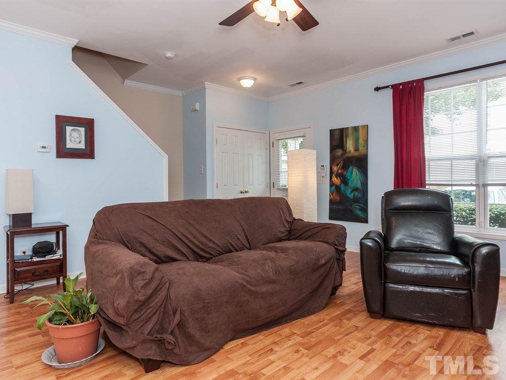 8149 Rhiannon Road Raleigh, NC 27613 - Photo 6 of 25 a living room with furniture and a large window