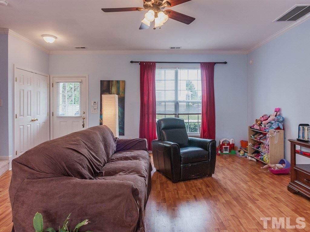 8149 Rhiannon Road Raleigh, NC 27613 - Photo 7 of 25 a living room with furniture and a flat screen tv