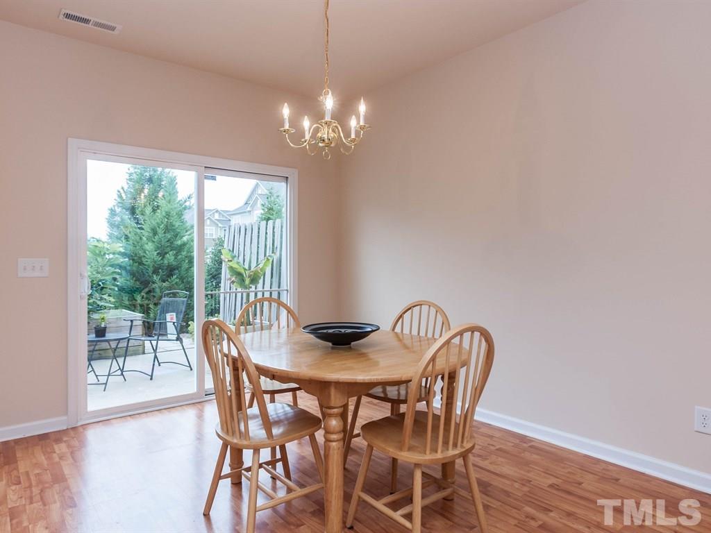 8149 Rhiannon Road Raleigh, NC 27613 - Photo 8 of 25 a view of a dining room with furniture window and outside view