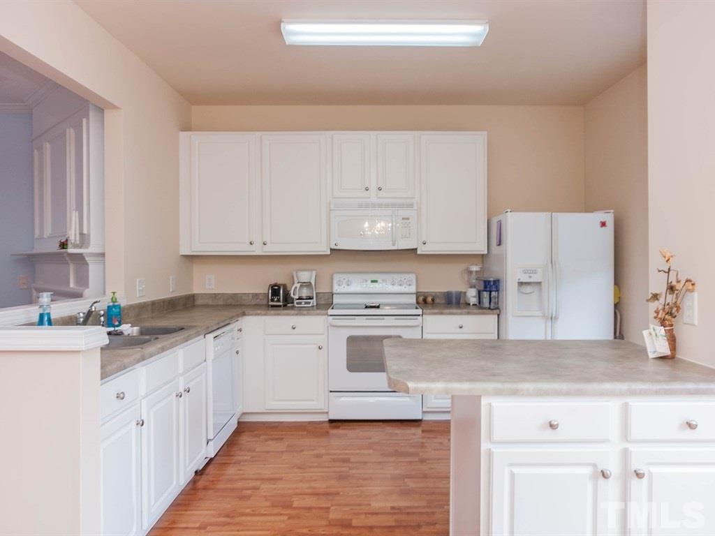 8149 Rhiannon Road Raleigh, NC 27613 - Photo 9 of 25 a large kitchen with cabinets appliances a sink and a counter space