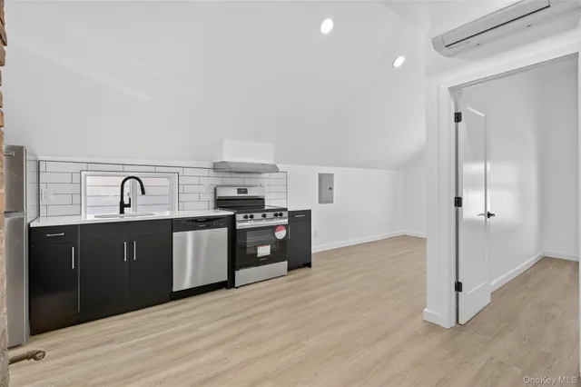 a kitchen with granite countertop a refrigerator and a sink