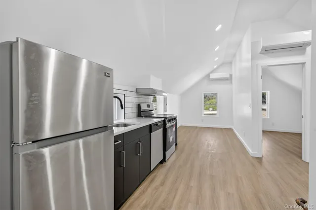 a kitchen with stainless steel appliances granite countertop a refrigerator and a stove