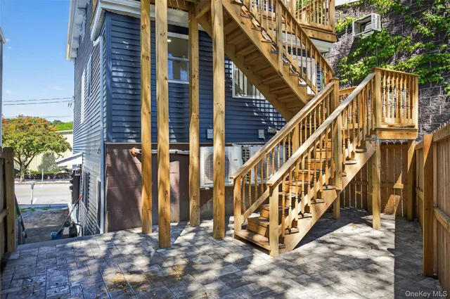 a view of a house with backyard and deck