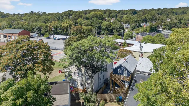 an aerial view of a house with yard