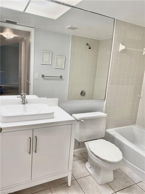 4955 Pepper Circle, Unit B204 Naples, FL 34113 - Photo 13 of 25 a bathroom with a sink a toilet a mirror and shower
