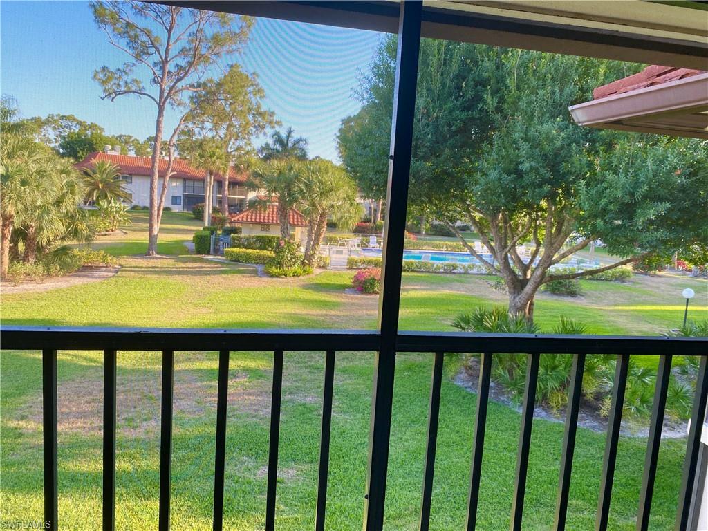 4955 Pepper Circle, Unit B204 Naples, FL 34113 - Photo 16 of 25 a view of backyard with large trees