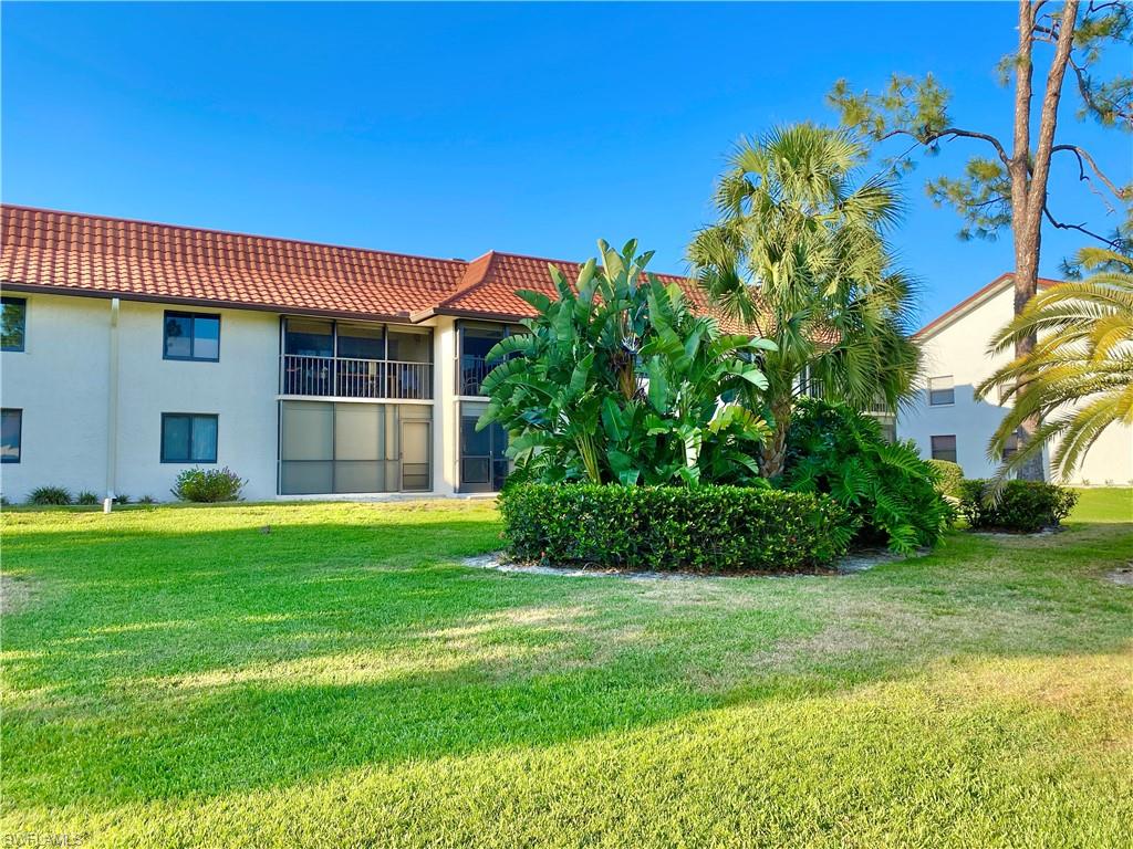 4955 Pepper Circle, Unit B204 Naples, FL 34113 - Photo 18 of 25 a front view of a house with a garden
