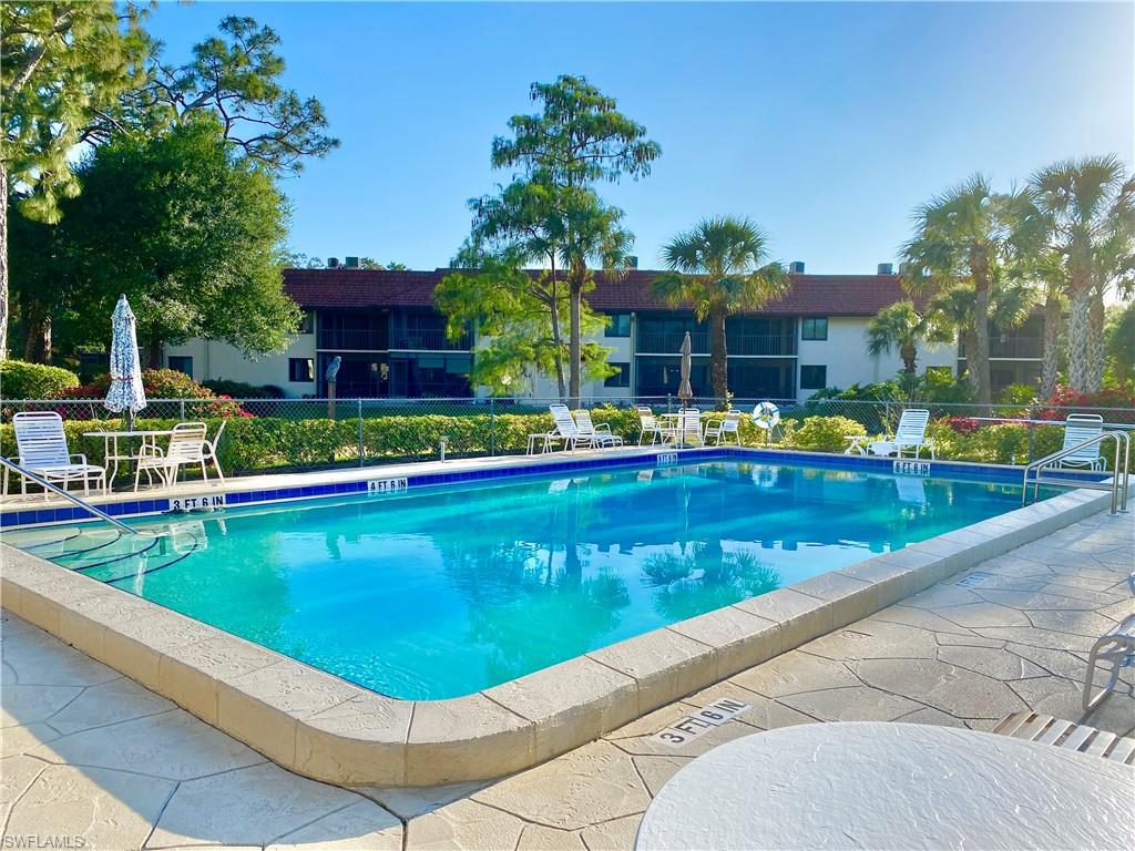 4955 Pepper Circle, Unit B204 Naples, FL 34113 - Photo 19 of 25 a view of a swimming pool with a patio