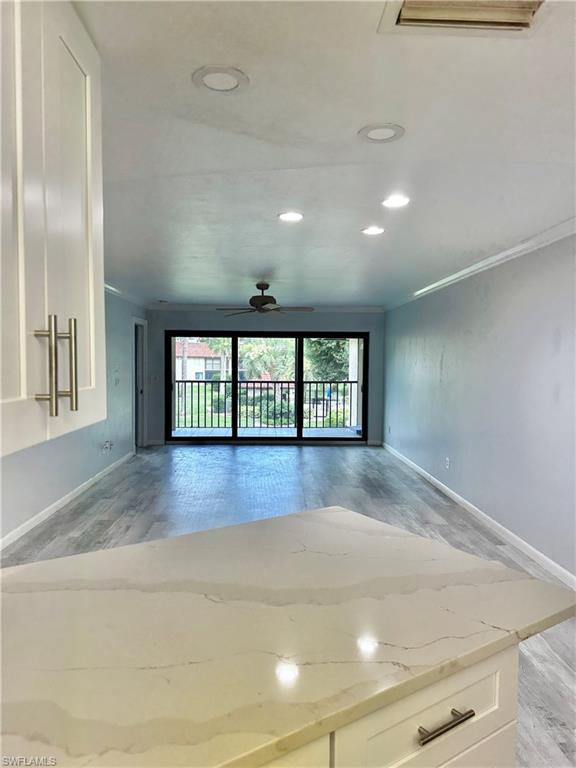 4955 Pepper Circle, Unit B204 Naples, FL 34113 - Photo 23 of 25 wooden floor in an empty room with a window