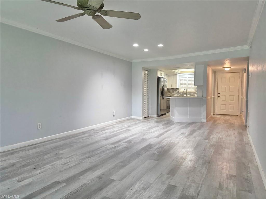 4955 Pepper Circle, Unit B204 Naples, FL 34113 - Photo 25 of 25 a view of a kitchen with a sink and dishwasher a refrigerator with wooden floor