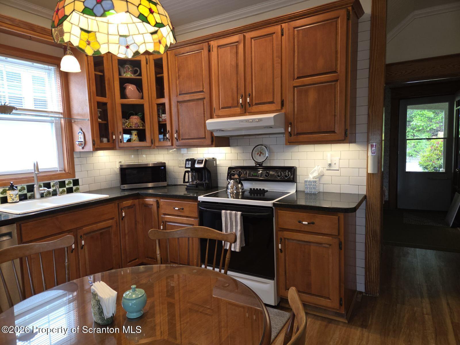 229 East Mountain Road Scranton, PA 18505 - Photo 24 of 47 a kitchen with stainless steel appliances granite countertop a sink dishwasher and cabinets with wooden floor